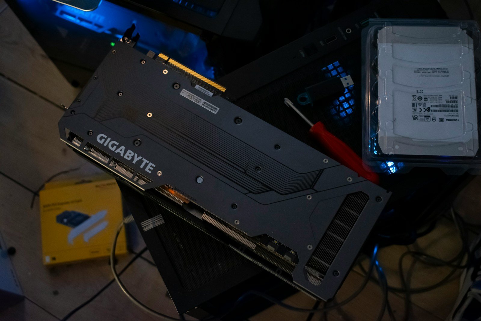 PC components sit on a cluttered desk.